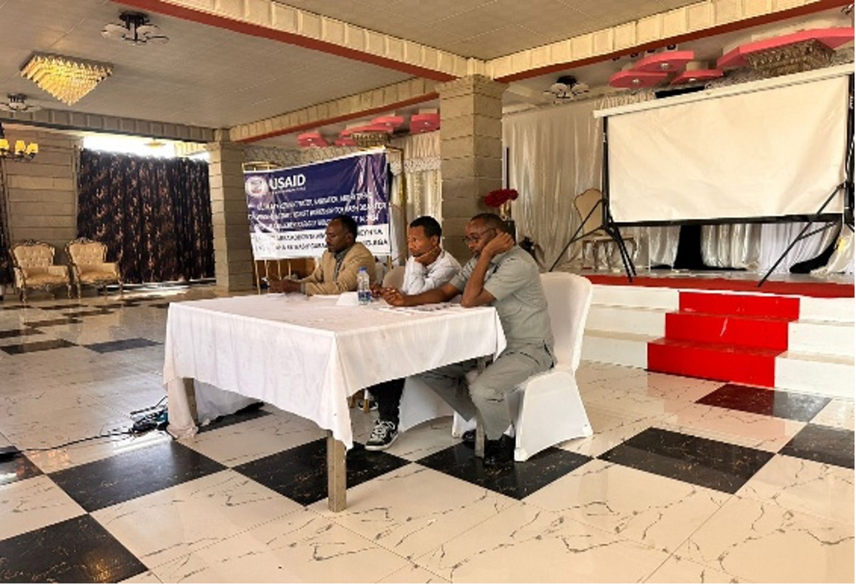 Community health education session with participants seated outdoors